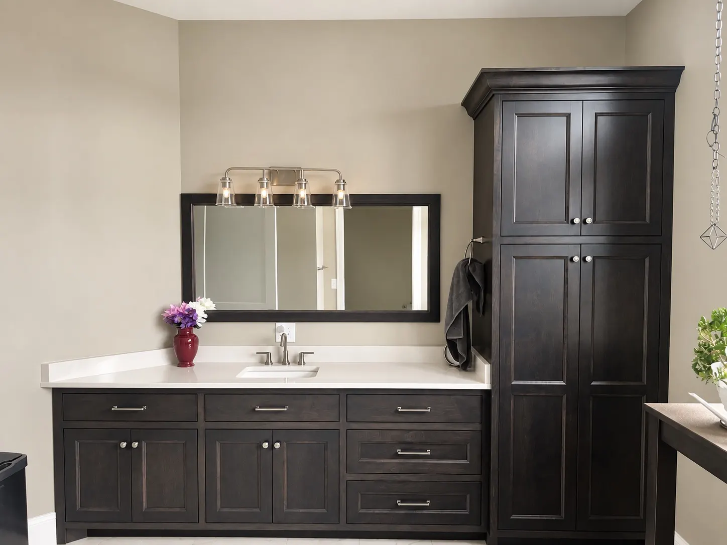 Dark stained bathroom vanity with a matching linen cabinet