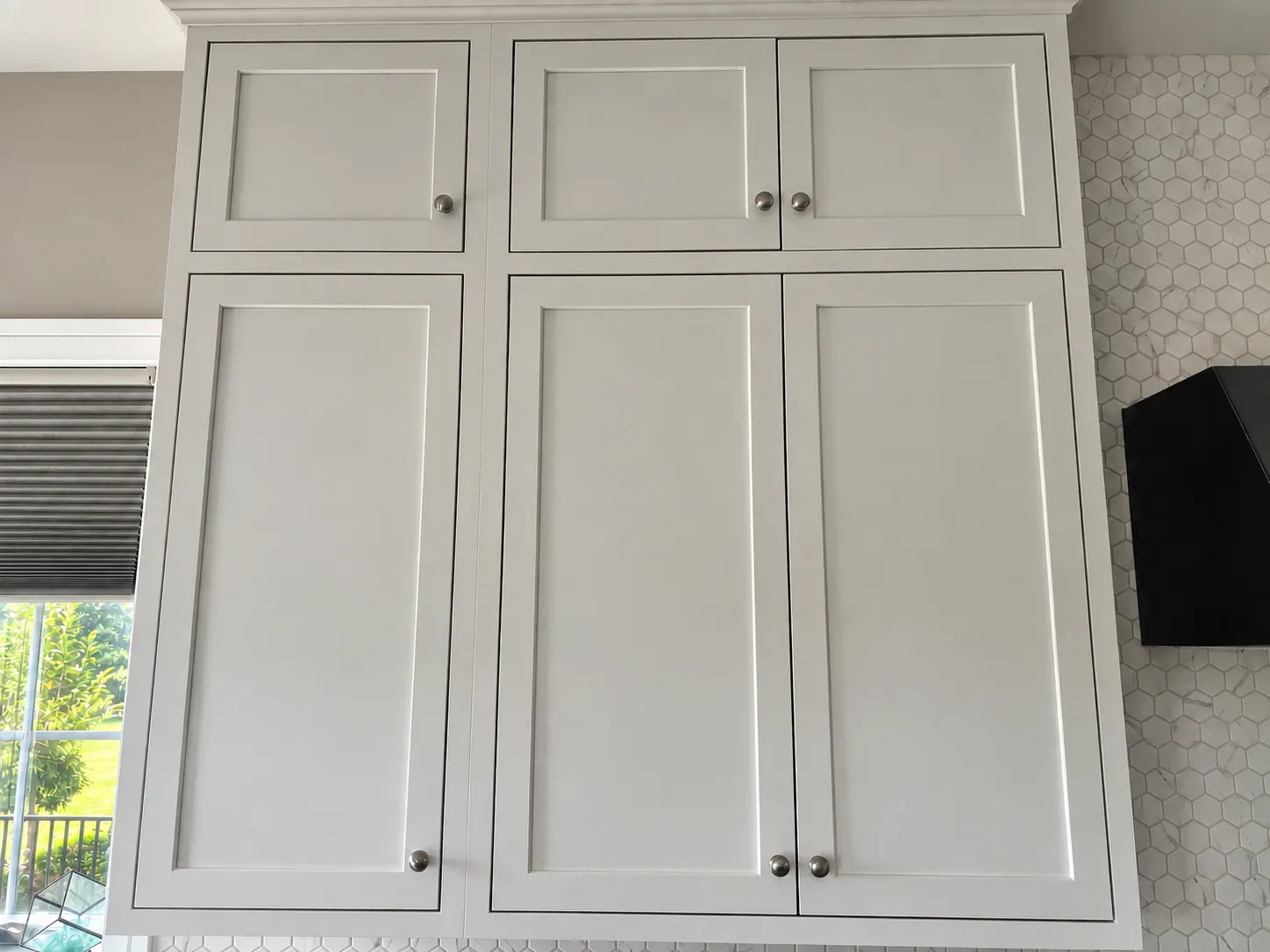 Painted upper kitchen cabinets with crown molding